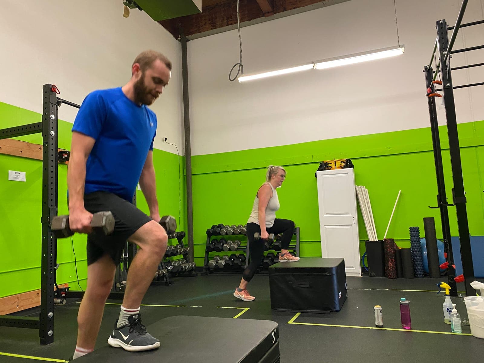 Two clients doing dumbbell step-ups