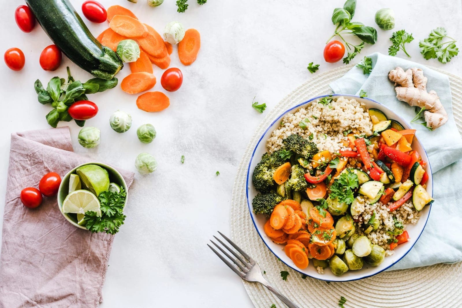 A bowl of grains, roasted vegetables and fresh produce